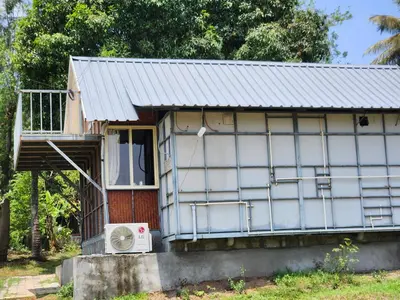 a small house with a window and a fan at Tusker Valley Bamboo Room Mudumalai by Privacy Homes in Mudumalai National Park