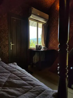a bedroom with a bed and a window at Tusker Valley Bamboo Room Mudumalai by Privacy Homes in Mudumalai National Park