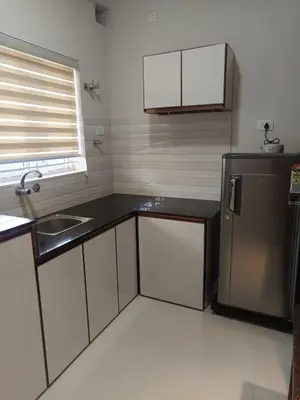a kitchen with a refrigerator and a sink at Divin Kalpaka 150 meter to temple in Guruvāyūr