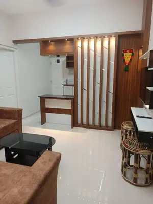 a living room with a couch and a table at Divin Kalpaka 150 meter to temple in Guruvāyūr