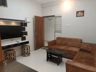 a living room with a couch and a television at Divin Kalpaka 150 meter to temple in Guruvāyūr