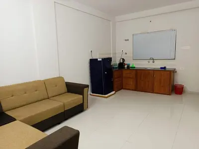 a living room with a couch and a tv at Divin Kalpaka 150 meter to temple in Guruvāyūr