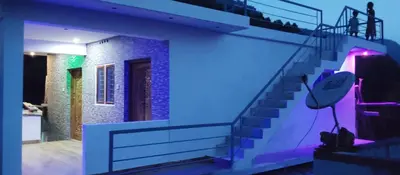 a room with a staircase with purple lights on it at Misty plaza in Vattavada