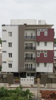 a large apartment building with white and red at DEJAVU TRANZS - Trishul in Coimbatore