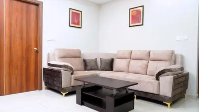 a living room with a couch and a table at DEJAVU TRANZS - Trishul in Coimbatore
