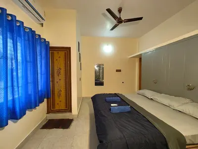 a bedroom with a bed and a ceiling fan at Galaxy Homestay Mysore 4bhk - Family friendly in Mysore