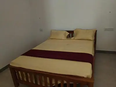 a bed with two pillows on it in a room at Johnnys Destination in Angamali