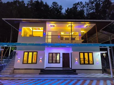 a house with a lit up facade at night at wild casa in Kanthalloor