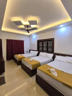 a bedroom with two beds and a ceiling at wild casa in Kanthalloor