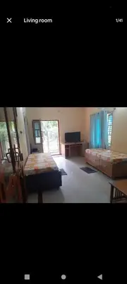 a bedroom with two beds and a living room at PARK VIEW In MYSORE CITY in Mysore