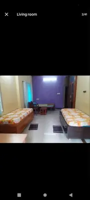 a bedroom with two beds and a living room at PARK VIEW In MYSORE CITY in Mysore