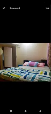 a bed with a colorful comforter in a bedroom at PARK VIEW In MYSORE CITY in Mysore