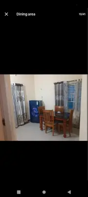 a picture of a dining area with a table and chairs at PARK VIEW In MYSORE CITY in Mysore