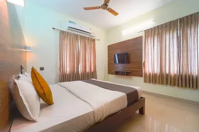 a bedroom with a large bed in a room at Chakraa Hotels in Coimbatore