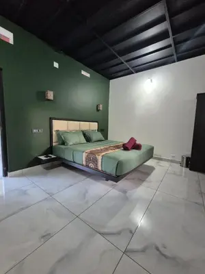 a bedroom with a bed in a green wall at Cabana banasura Wayanad 2bhk in Padinjarathara