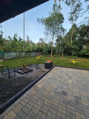 a patio with a fire pit in a park at Cabana banasura Wayanad 2bhk in Padinjarathara