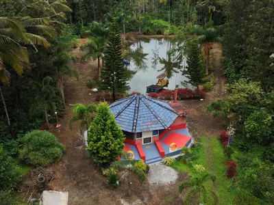 an overhead view of a house in the middle of a lake at Rising Surya Homestay in Kushālnagar