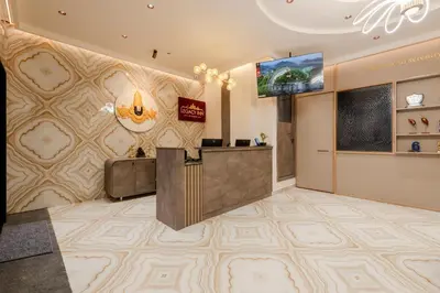 a lobby with a reception desk and a flat screen tv at Legacy Inn, Mysore in Mysore