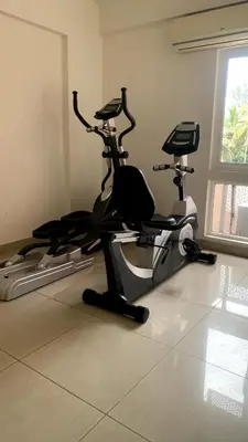 a gym with two exercise bikes in a room at Aarav Stays in Mysore