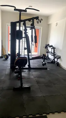 a gym with several tread machines in a room at Aarav Stays in Mysore