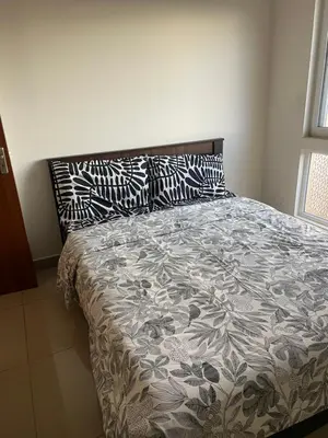 a bed in a bedroom with pillows on it at Aarav Stays in Mysore