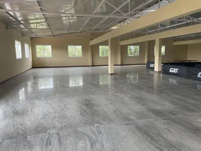 an empty room with a concrete floor in a building at Aarav Stays in Mysore