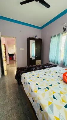 a bedroom with a large bed in a room at Mysore Stopover in Mysore