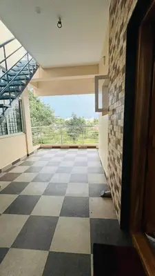 a room with a checkered floor in a building at Mysore Stopover in Mysore