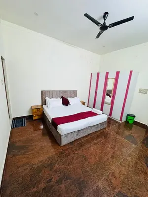 a bedroom with a bed and a ceiling fan at LUXE Penthouse 4BHK with Swimming pool in Mysore