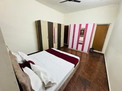 a bedroom with a large white bed in a room at LUXE Penthouse 4BHK with Swimming pool in Mysore