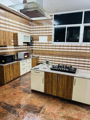 a large kitchen with wooden walls and a counter top at LUXE Penthouse 4BHK with Swimming pool in Mysore
