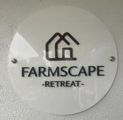 a sign with the name of a farmagency retreat at Farmscape Retreat in Gonikoppal