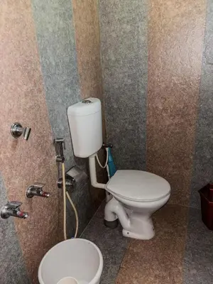 a bathroom with a toilet and a sink at kadalundi Heritage in Vallikunnu