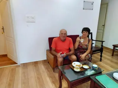 a man and a woman sitting on a couch at kadalundi Heritage in Vallikunnu