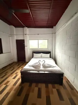 a bedroom with a large bed in a room at Organic Farmers Tent & Trekking in Yedapalli