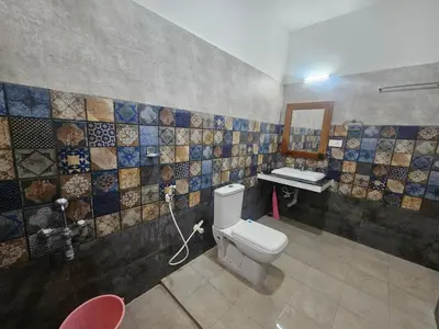 a bathroom with a toilet and a sink at SHI's Chettinad Courtyard Villa a 3BHK near Adiyogi in Alāndurai