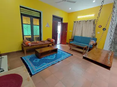 a living room with a couch and a swing at SHI's Chettinad Courtyard Villa a 3BHK near Adiyogi in Alāndurai