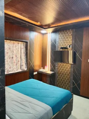 a bedroom with a blue bed in a room at Sri Krishna residency in Ooty