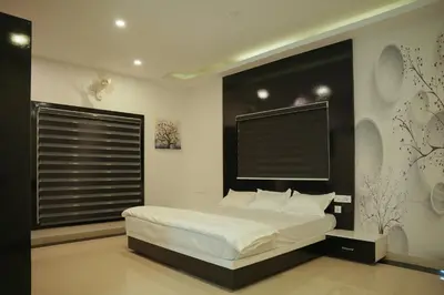 a bedroom with a bed and a large window at The Glen By Bloobuck in Ambalavayal