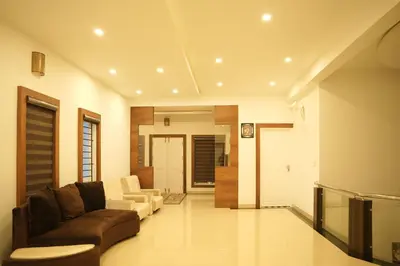 a living room with a couch and two chairs at The Glen By Bloobuck in Ambalavayal