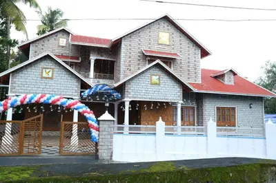 a house with an arch in front of it at Villa Tharavadu in Angamali
