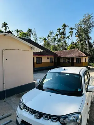 a white car parked in front of a house at Festoon Villa in Sultan Bathery