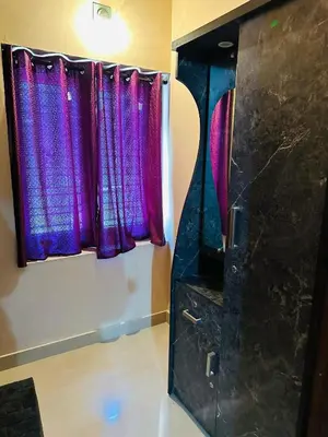 a bathroom with purple curtains and a mirror at Festoon Villa in Sultan Bathery