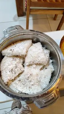 a pan with some food in it on a table at South point homestay in Virajpet