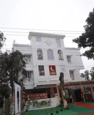 a large white building with a lot of windows at Goldwins Grand A comfort stay in Coimbatore