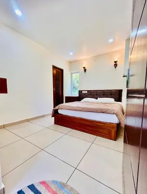 a bedroom with a large bed and a window at Wild Bliss in Sultan Bathery