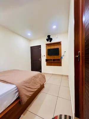 a bedroom with a bed and a flat screen tv at Wild Bliss in Sultan Bathery