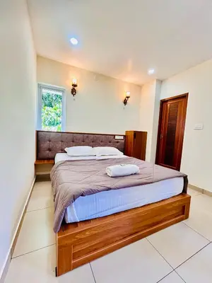 a bedroom with a bed with two pillows on it at Wild Bliss in Sultan Bathery