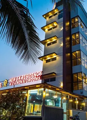 a tall building with a sign in front of it at New SK Residency Mysore in Mysore