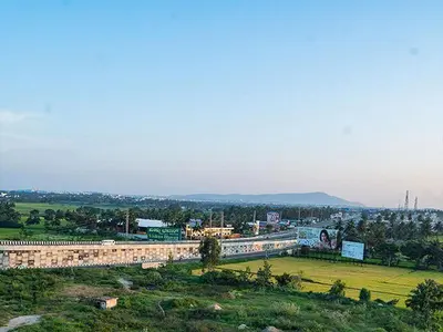 a building on a hill with a city in the background at New SK Residency Mysore in Mysore